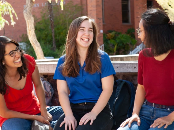 three girls laughing together